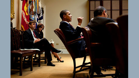 Obama tips his chair back in white house staff meeting