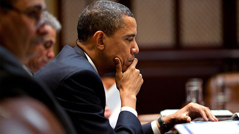 Obama works at solving a tough suduko puzzle