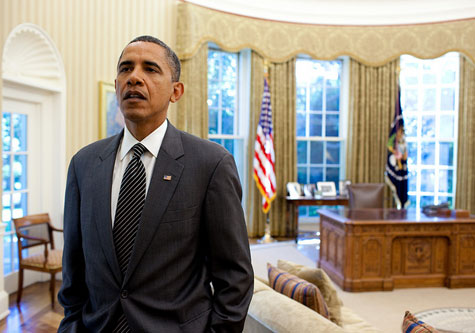 Obama standing in an empty Oval Office 
